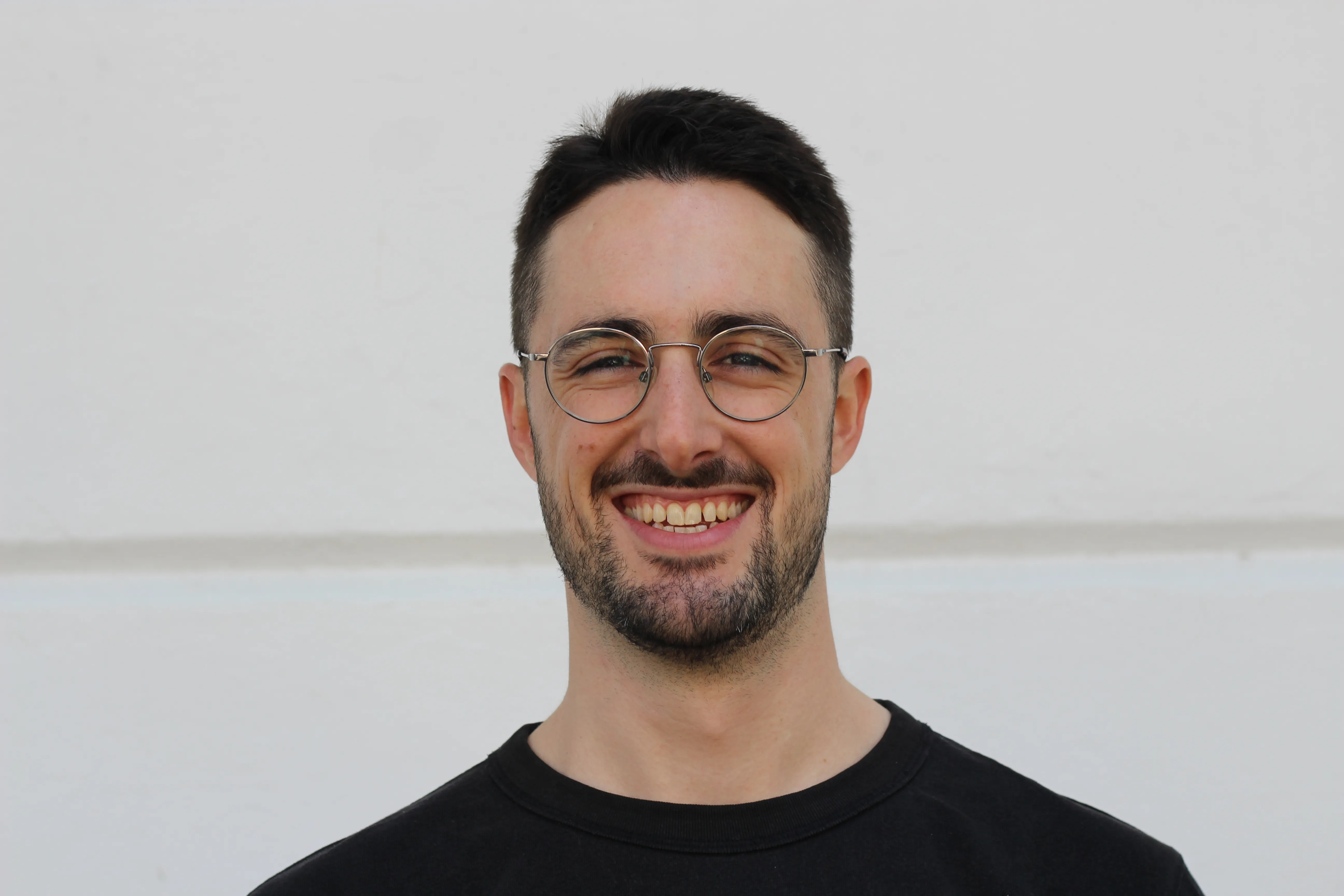 A picture of me with glasses and a big smile